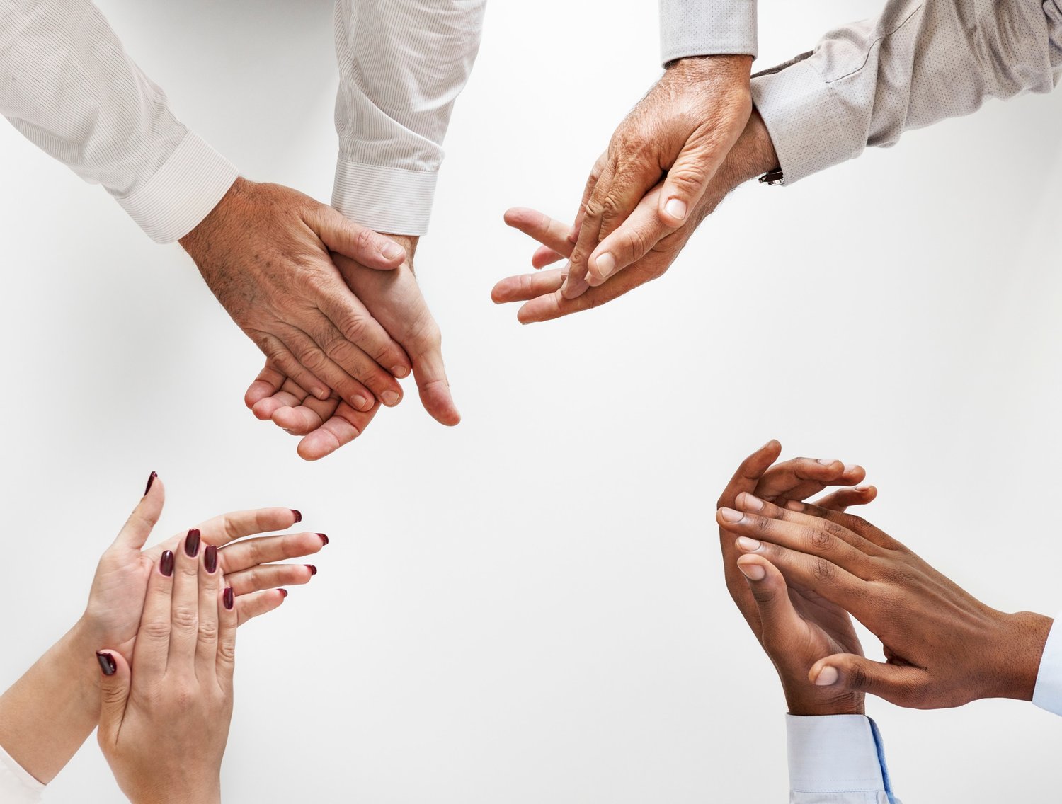 A diverse group of hands reaching towards one another