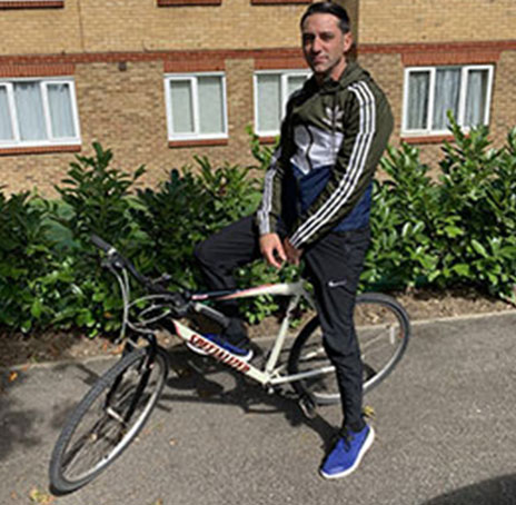 An Albany resident with his bicycle outside his home